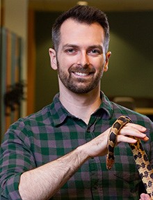 Stephen Ferguson holding a snake
