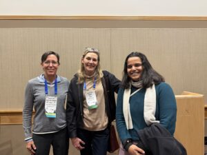 Suzy Renn and Caitlin Gabor (DAB chair and secretary) celebrating the Marlene Zuk best presentation winner Sunishka Thaker at the Coffee social